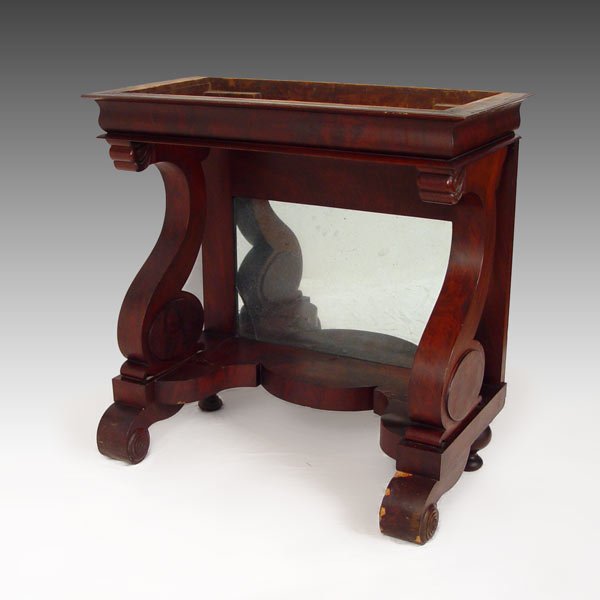 EMPIRE PERIOD MAHOGANY PIER TABLE: EMPIRE PERIOD MAHOGANY PIER TABLE: Mirrored back between two scrolled elephant trunk supports. Scroll feet in the front, bun feet in rear. 35" tall x 36" wide x 18" deep.
