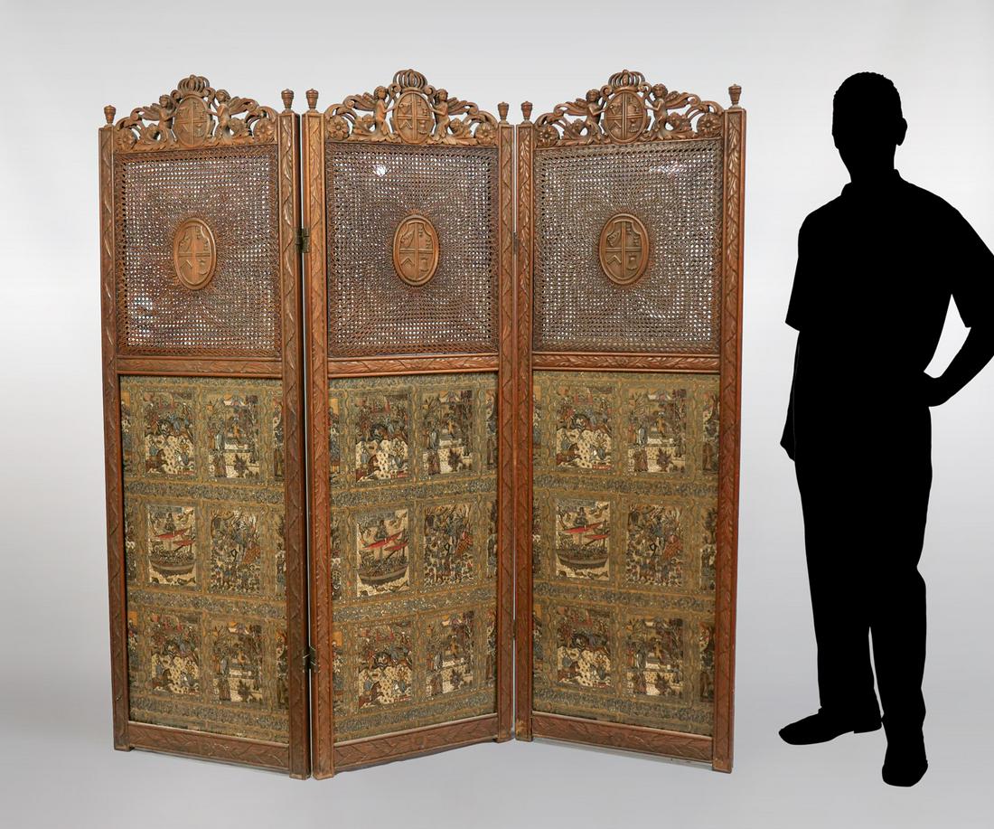 CARVED ENGLISH SCREEN WITH CANE WORK: CARVED ENGLISH SCREEN WITH CANE WORK: Late 19th century English three-fold screen with fanned caning, over upholstered panels, having a figural middle eastern pattern. Carved foliate framework surmoun