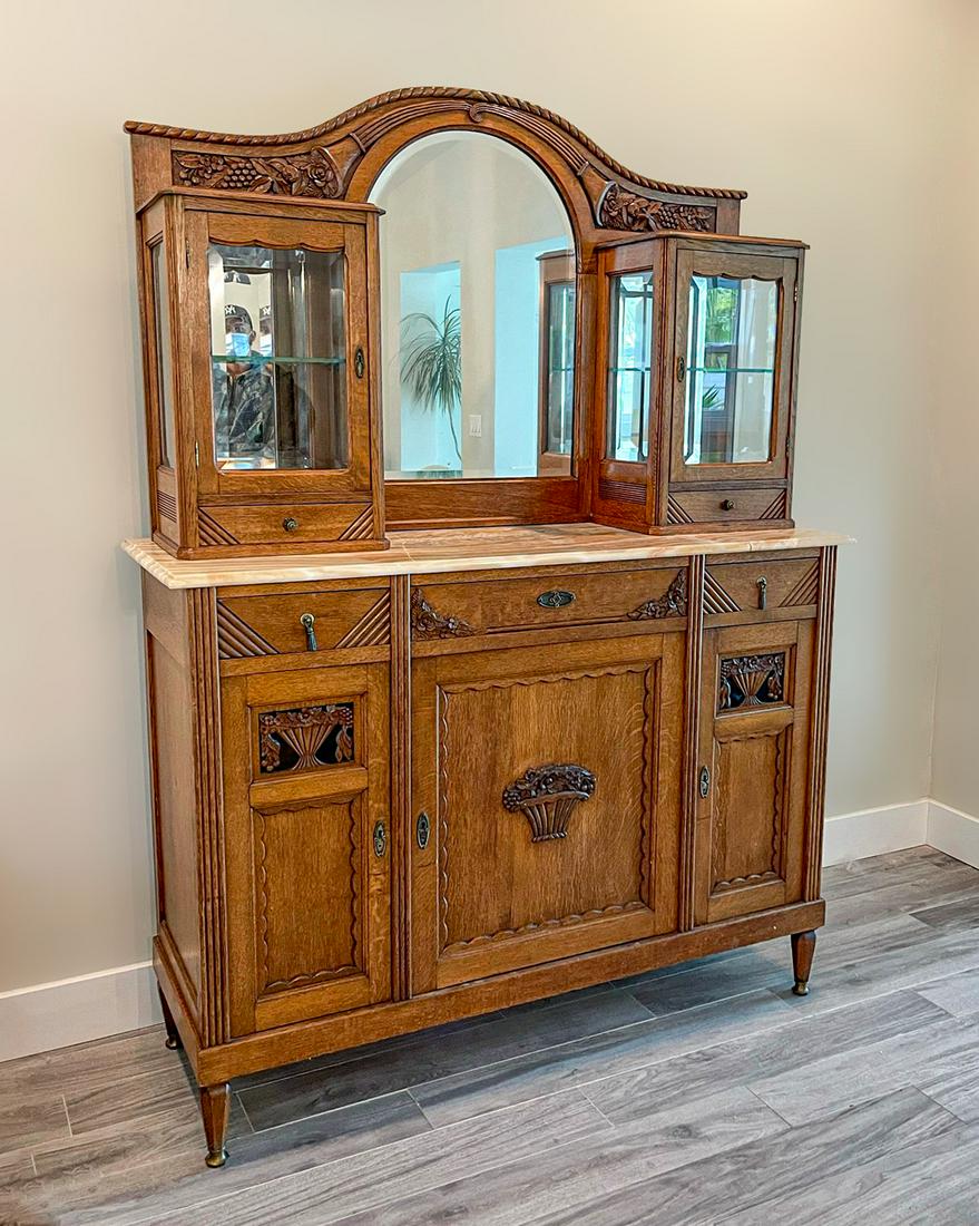 MARBLE TOP MIRROR BACK CHINA HUTCH: MARBLE TOP MIRROR BACK CHINA HUTCH: Arched mirror, flanked by 2- lighted displays. Resting on a marble top 3 drawer, 3 drawer cabinet. Raised on hexagonal tapered legs with metal mounted feet. Approx.