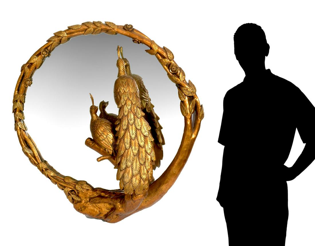 LARGE CARVED UNION CITY GILT PEACOCK MIRROR: LARGE CARVED UNION CITY GILT PEACOCK MIRROR: Large Union City Mirror & Table Company circular mirror with gilt intertwining branch frame with floral & foliate. Two perched peacocks looking into mirror
