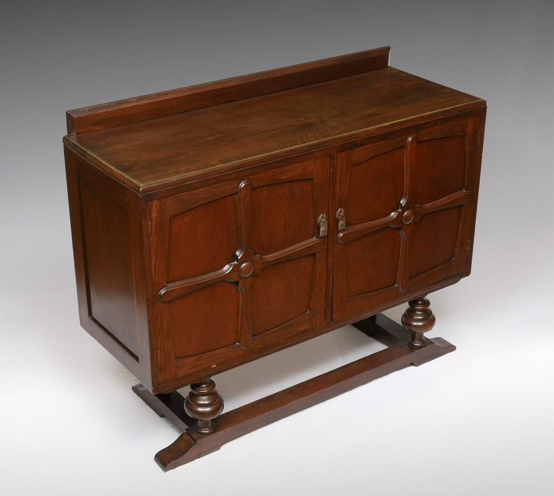 ART DECO 2 DOOR COMPARTMENTED SIDEBOARD: ART DECO 2 DOOR COMPARTMENTED SIDEBOARD: Early 20th century sideboard, by Cox & Falconer, Darlington. Raised on front turned legs with slat feet. Metal tag attached at verso. Approx. 38.5" h x 48" l x