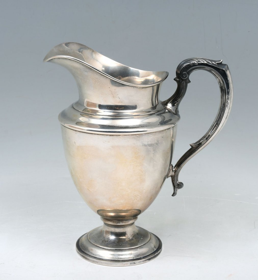 GORHAM STERLING SILVER PITCHER: GORHAM STERLING SILVER PITCHER: Approx. 19.76 Troy ounces. Scrolling foliate designed handle. Impressed marks at underside, #903. Approx. 9.5" h x 8.5" l x 5.5" w.