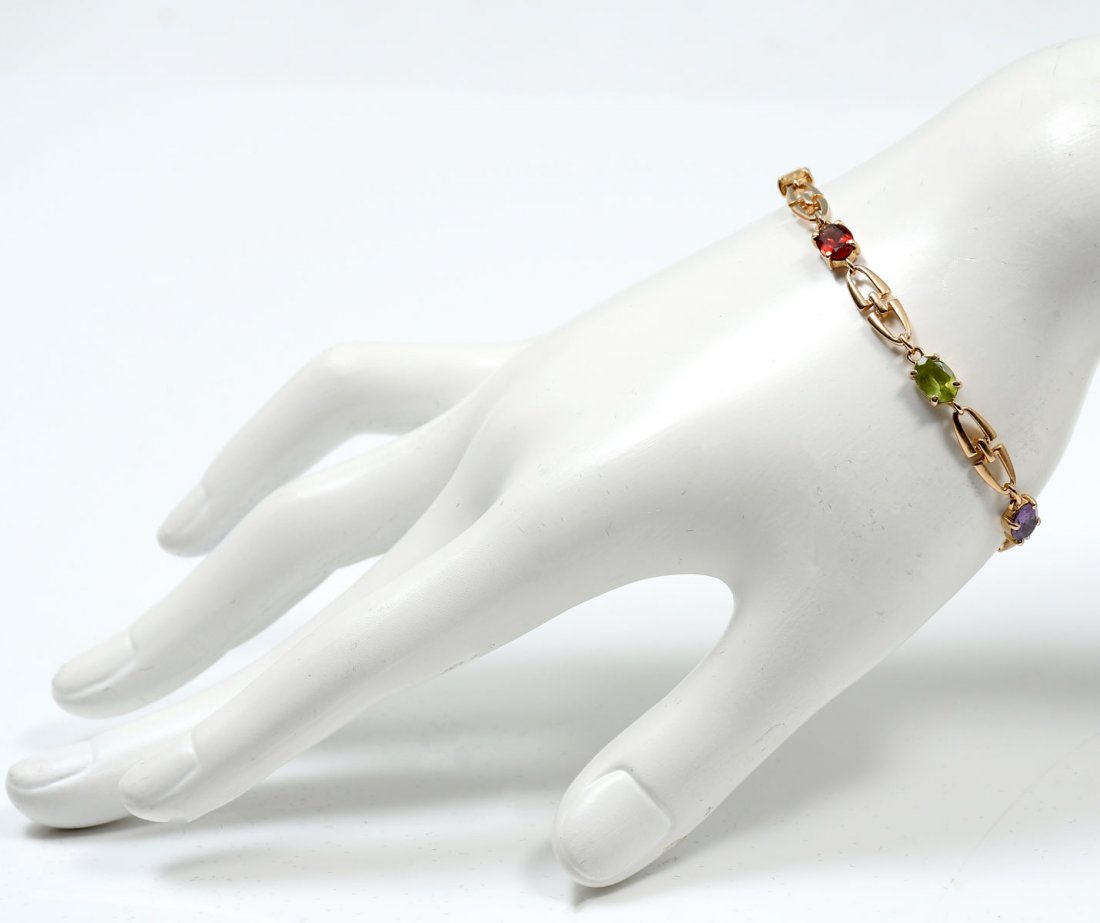 14K GEMSTONE BRACELET: 14K GEMSTONE BRACELET: 14K yellow gold bracelet contains faceted gemstones. Amethyst, topaz, garnet, citrine and peridot. WEIGHT: 2.00 Ct. Approx. The gemstones are prong set. Weight: 7.2 grams. Lengt