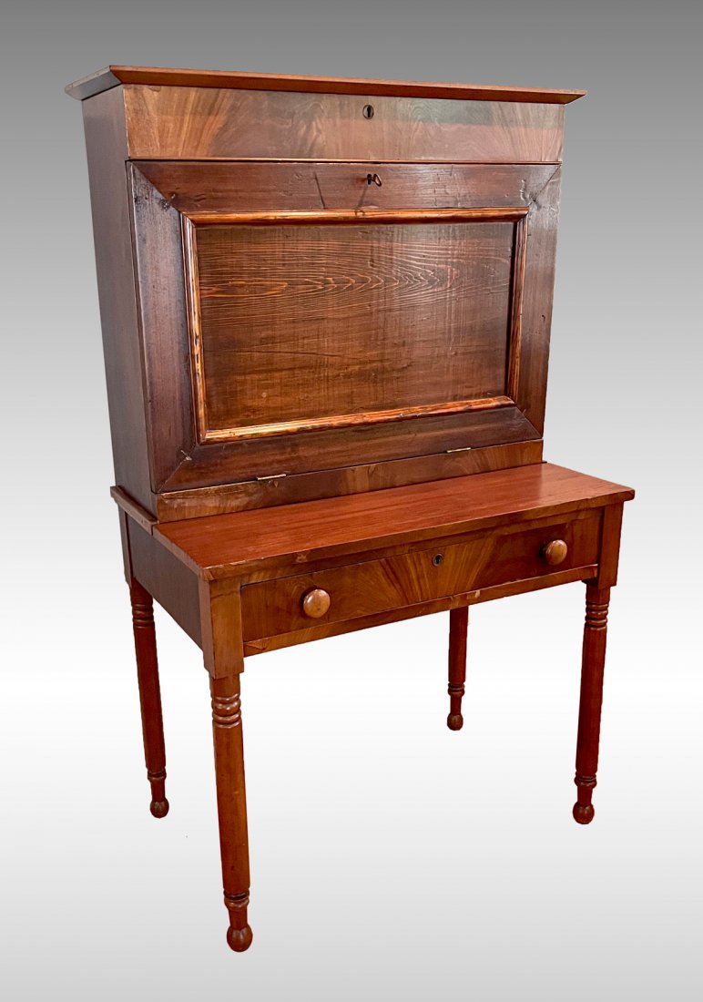 DROP FRONT SECRETARY DESK WITH KEY: DROP FRONT SECRETARY DESK WITH KEY: Drop front compartmented desk, surmounted by a locking compartment. Resting on a single drawer base with turned legs. Approx. 58.75" h x 36.25" l x 21" w.