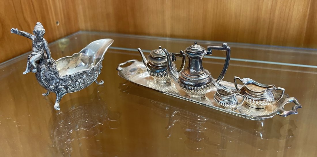 STERLING CHERUB CREAMER AND MINIATURE TEA SET: STERLING CHERUB CREAMER AND MINIATURE TEA SET: Approx. 3.82 Troy ounces. Comprising; 1- Cherub surmounted Sterling creamer. 1- English Miniature Sterling five piece tea set. Including; 1- Tray, 1- Cof