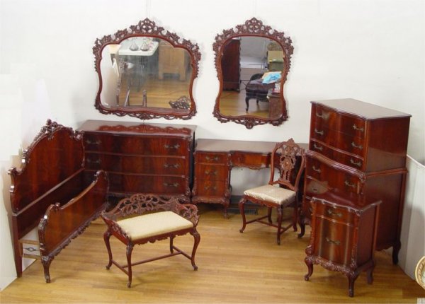 9 PIECE CARVED FRENCH BEDROOM SUITE: EARLY 20TH C FRENCH STYLE CARVED BEDROOM SET: Richly grained and ornately carved with serpentine front chests. To include full size BED (49" h. x 60" w. x 76" long), TALL CHEST (55" h. x 36" x 20"0, D