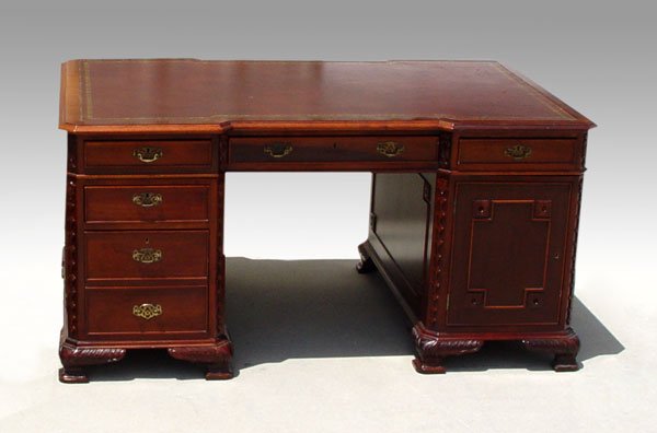 MAHOGANY LEATHER TOP PARTNERS DESK: LEATHER TOP DOUBLE PEDESTAL PARTNERS DESK: Mahogany with embossed leather top. Carved stiles, applied molding, locks with key (included). 30" h. x 60 1/2" x 39 1/2"