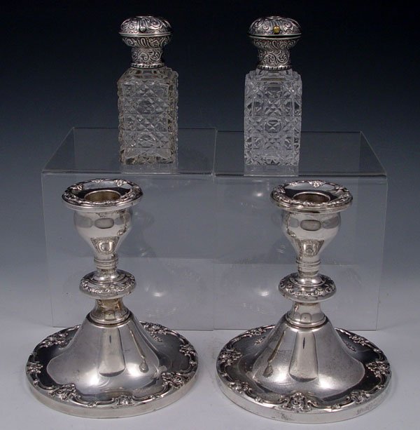 1889 AND 1908 LONDON SILVER: 4 PIECE LONDON STERLING MOUNTED VINEGAR & OIL PLUS CANDLESTICKS: To include 1) Stewart Clifford 1889 London, repousse top with glass stopper. 4 1/4'' h. 2) Charles Asprey & George Asprey 1908 London, 