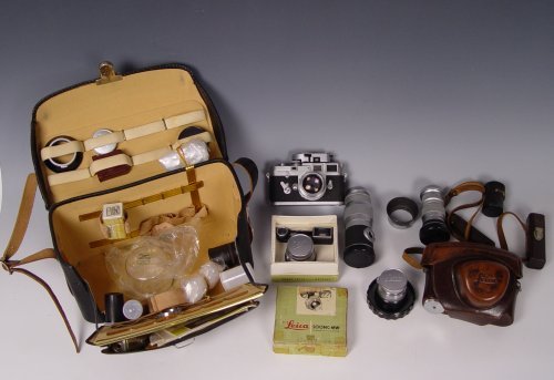 LEICA M3 884825 CAMERA OUTFIT WITH 4 LENSES: LEICA M3 884825 CAMERA OUTFIT: Circa 1957, comes with Leica meter MR, 4 lenses, assorted accessories and instruction booklets in leather case. Lenses read 1) Leitz Wetzlar Hektor f=13.5cm. 2) Leitz We