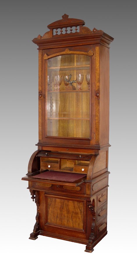 PETITE VICTORIAN CYLINDER ROLL SECRETARY DESK: A RARE EASTLAKE VICTORIAN CYLINDER ROLL SECRETARY DESK: Walnut embellished with burl veneer. Single door secretary top fitted with 3 adjustable shelves. Base with cylinder top over full length drawer.