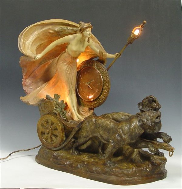 GOLDSCHEIDER TERRACOTTA NOUVEAU FIGURAL CLOCK: GOLDSCHEIDER GILDED TERRACOTTA NOUVEAU FIGURAL CLOCK SIGNED CAPEQUE (STANISLAUS): Model of Europa in a chariot, holding a light, being pulled by a pair of tigers. Replaced movement, 25" h. x 32" x 13"