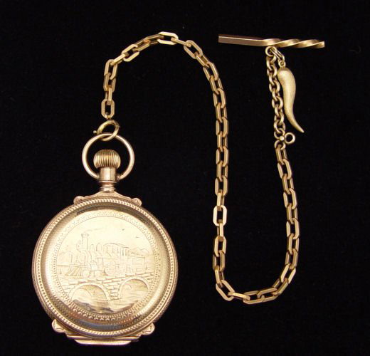 AMERICAN WALTHAM 18K POCKET WATCH CA.1890: AMERICAN WALTHAM 18K POCKET WATCH CA. 1890: 18K Hunters Box Case with engraved steam engine on front and sail boat Schooner verso. The dial is marked as American Waltham. The movement is a 17 jewel, 1