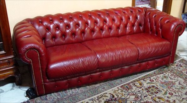 RED LEATHER CHESTERFIELD SOFA: RED LEATHER CHESTERFIELD SOFA: Richly worn to nice patina. Brass studded arm fronts, bun feet, tufted back. 27''h. x 81'' x 37''.