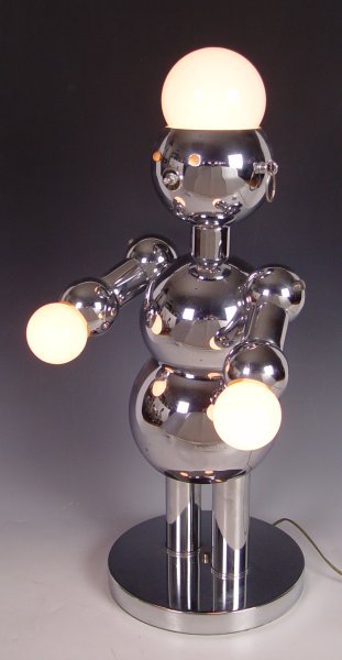 TORINO POLISHED CHROME FIGURAL ROBOT LAMP: TORINO POLISHED CHROME FIGURAL ROBOT LAMP: Mid century Italian lamp, three way switch in his nose. 28 1/2" tall, base is 11" dia. Torino label.