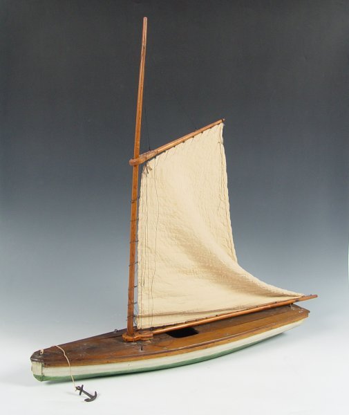 VICTORIAN CHILD'S POND BOAT: VICTORIAN CHILD'S POND BOAT: Circa early 20th century. Original green / white paint and single cotton sail. Handcrafted with brass plaque of beaver. Measures 32 1/2" h. x 30" x 7 1/4".