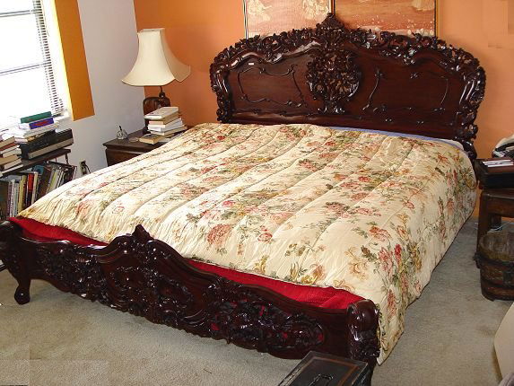 PROFUSELY CARVED KING SIZE MAHOGANY BED: PROFUSELY CARVED KING SIZE MAHOGANY BED: Headboard measures 56 1/2" h x 85". Foot measures 26 3/4" x 86 1/2"