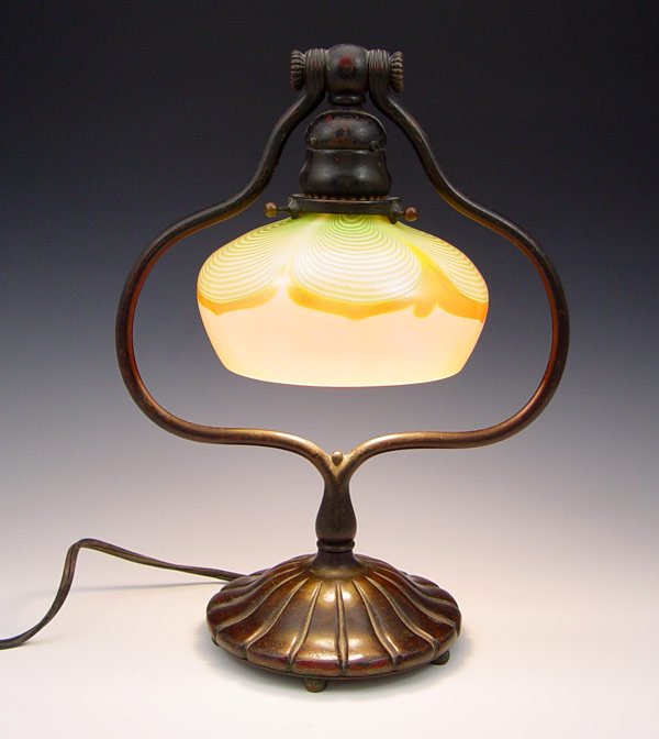 TIFFANY STUDIOS HARP LAMP 419 w/ SIGNED SHADE: TIFFANY STUDIOS HARP LAMP 419 WITH SIGNED PULLED FEATHER SHADE: Bronze base stamped Tiffany Studios New York 419. Pulled feather design shade, signed L.C.T. Lamp base measures 13'' h. x 9 5/8''. Shade
