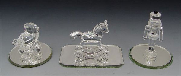 SWAROVSKI CRYSTAL ROCKING HORSE , NUTCRACKER, BUGG: 3 SWAROVSKI CRYSTAL FIGURES: "When We Were Young" - 1994 Rocking Horse, 2 3/4"; 1996 Baby Carriage, retired 1999, 2 1/8". "Exquisite Accents" - Nutcracker, retired 2003, 3 1/4". All have boxes.