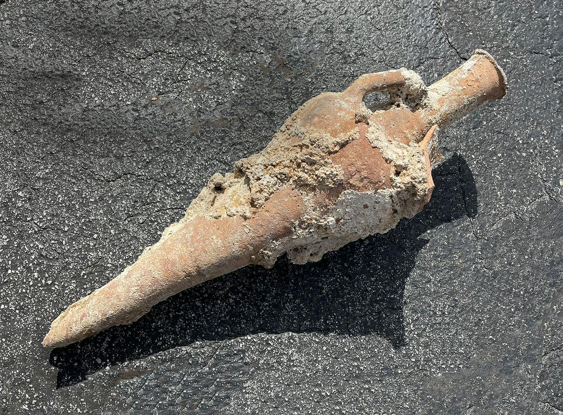 ARCHAIC ROMAN GREEK AMPHORA SUNKEN VESSEL: ARCHAIC ROMAN GREEK AMPHORA SUNKEN VESSEL: Encrusted ancient vessel retrieved from the sea floor. Approx. 30.5'' h x 9.5'' w. Provenance; Recovered by Captain Herman B. Conley during a Mediterranean d