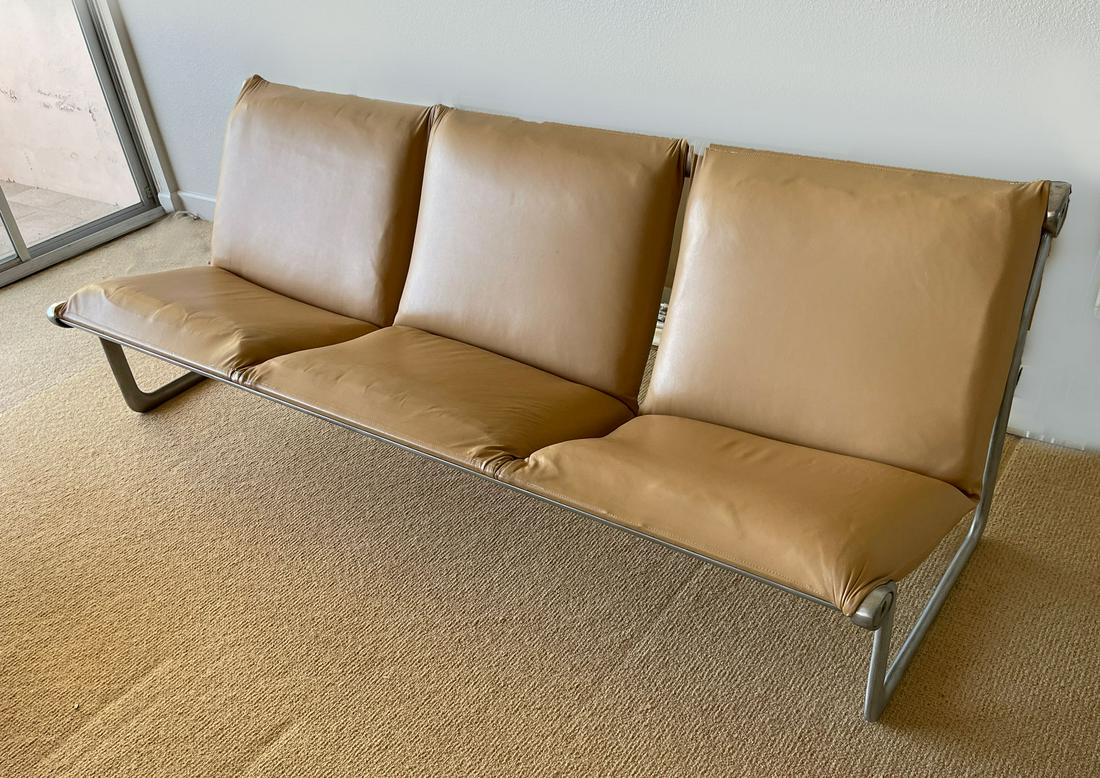 MORRISON & HANNAH KNOLL INTERNATIONAL SLING SOFA: MORRISON & HANNAH KNOLL INTERNATIONAL SLING SOFA: Mid-century modern Sling sofa, having an aluminum frame with tan leather upholstery. Approx. 28'' h x 80.75'' l x 30'' w.