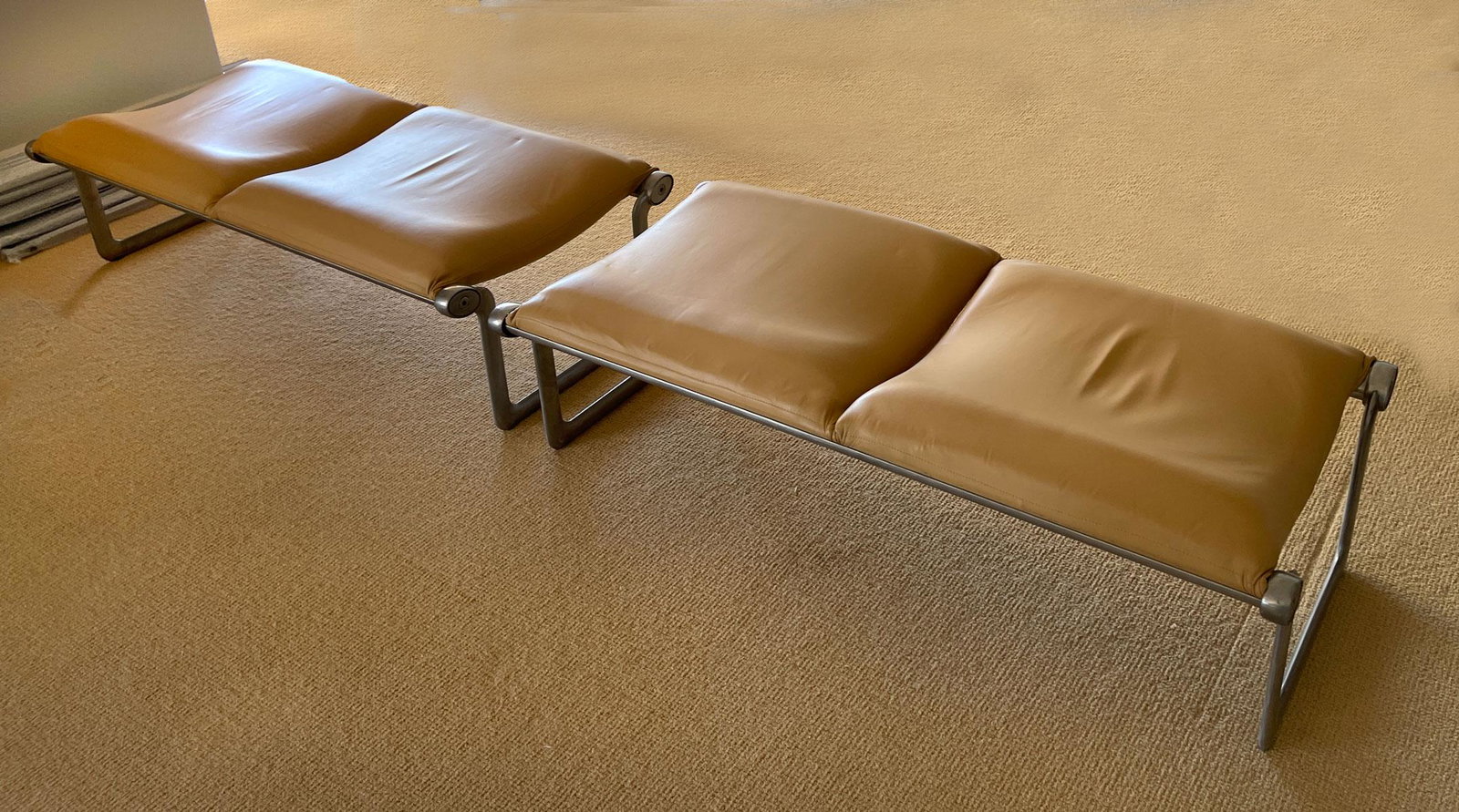 TWO MORRISON & HANNAH KNOLL INTERNATIONAL BENCHES: TWO MORRISON & HANNAH KNOLL INTERNATIONAL BENCHES: Pair of mid-century modern benches, having an aluminum frame with tan leather upholstery. Approx. 16'' h x 55'' l x 25.5'' w.