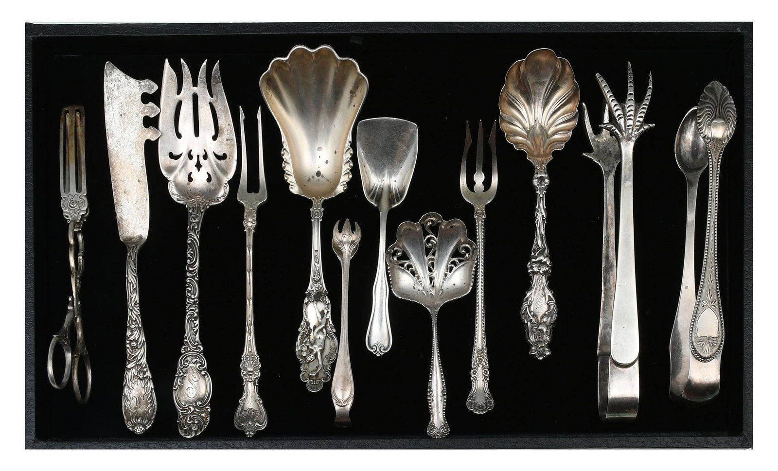 12 PC. ORNATE SILVER COLLECTION: 12 PC. ORNATE SILVER COLLECTION: Approx. 12.82 Troy ounces (.925) & 1.07 Troy ounces (.800). Comprising; 1- German Silver Toast tongs, 1- Tiffany & Co. Cheese knife, 1- Alvin Mfg. pierced Meat fork, 1