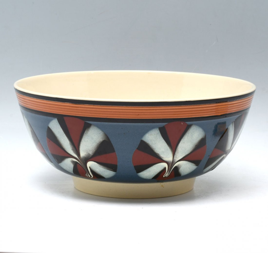 LARGE DON CARPENTIER MOCHA WARE BOWL: LARGE DON CARPENTIER MOCHA WARE BOWL: Having a ribbed encompassing band at rim and cat's eye design. Impressed marks at underside. Approx. 4.25" h x 10.25" w.