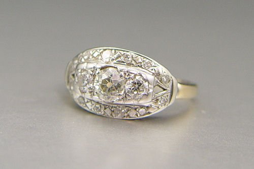 1940'S TWO TONE 3 STONE DIAMOND RING 1ctw: 1940'S TWO TONE 3 STONE DIAMOND RING: 14K yellow and white gold ring contains one old mine cut diamond, two old European round cut diamonds and twelve round single cut diamonds. WEIGHT: 1.00 Ct. Appro