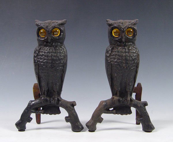 CAST IRON OWL ANDIRONS WITH GLASS EYES: CAST IRON OWL ANDIRONS WITH GLASS EYES: Painted black. Yellow glass eyes. Measures 13" x 8 1/4" x 5 1/4".