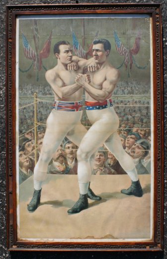 19th C. BOXING CHROMOLITHOGRAPH CORBETT MITCHELL: 19TH C. WORLD CHAMPIONSHIP BOXING CHROMOLITHOGRAPH OF CHARLIE MITCHELL AND "GENTLEMAN" JIM CORBETT: 24" x 14 1/2" sight size, period wood frame with wear, 26" x 16 1/2". This fight was to be the first