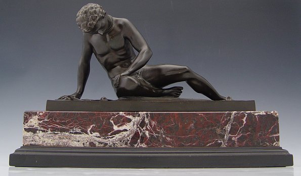 GLADENBECK AND SOHN SLAVE WARRIOR BRONZE: GLADENBECK AND SOHN SLAVE WARRIOR BRONZE: 5 3/4'' h., 5 7/8'' w., incised AKt-Ges, circa 1910, superior red/pink period marble plinth, 2 1/2'' h., 12 3/4'' w., 5 1/2'' d.