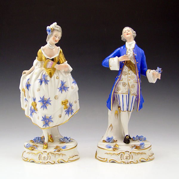 2 PORTUGUESE FINE PORCELAIN FIGURINES: 2 PORTUGUESE FINE PORCELAIN FIGURINES: Viennese man and woman, gold and blue accents, 10" tall.