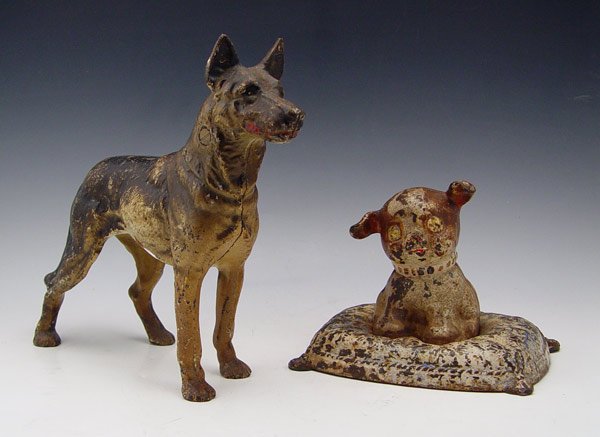 CAST IRON HUBLEY DOG BANK & GERMAN SHEPHERD : CAST IRON HUBLEY DOG BANK & GERMAN SHEPHERD DOORSTOP: To include 1) German Shepherd doorstop. 10" h. x 13 1/2". 2) Hubley Fido on Pillow still bank. 5 3/4" h. x 7 1/2".