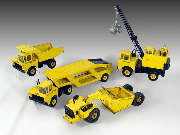 4 PIECE COLLECTION OF VINTAGE TONKA TRUCKS: 4 PIECE COLLECTION OF VINTAGE TONKA TRUCKS: To include Crane, Mighty Scraper, Mighty Car Carrier, Dumptruck. Largest piece measures 18" h x 28" x 7 3/4".