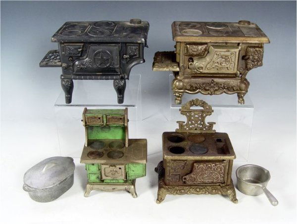 COLLECTION OF 4 CHILDS CAST IRON TOY STOVES: COLLECTION OF 4 CHILDS CAST IRON TOY STOVES: To include 1) "Favorite" with original green paint. 7 1/4" h. x 5 3/4" x 3 3/4". 2) "Eagle" 7 3/4" h. x 7 1/4" x 5 1/4". Missing 2 burner covers. 3) Unmark