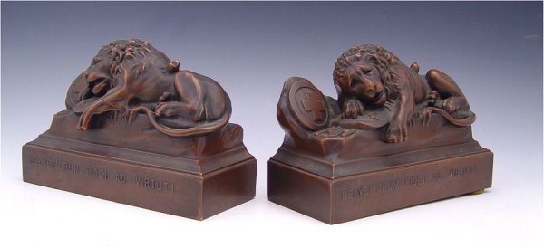 JENNINGS BROS LION OF LUCERNE FIGURAL BOOKENDS: JENNINGS BROS LION OF LUCERNE FIGURAL BOOKENDS: Bronzed patinated cast metal featuring the Lion of Lucerne. Marked JB 1570. 5" h. x 7 1/2" x 3".
