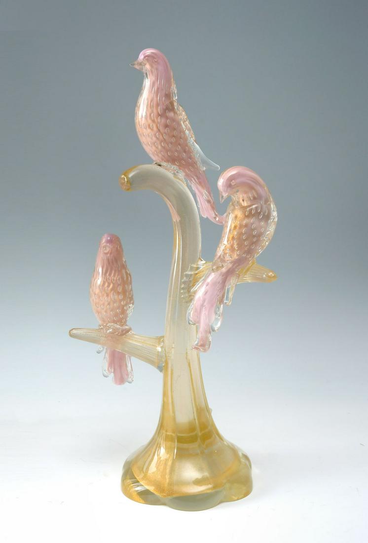 MURANO ART GLASS BIRD GROUPING: MURANO ART GLASS BIRD GROUPING: Three pink birds with controlled air bubbles, perched upon a tree form base with gold flecking throughout. Approx. 20.25'' h x 10'' l x 6.5'' w.