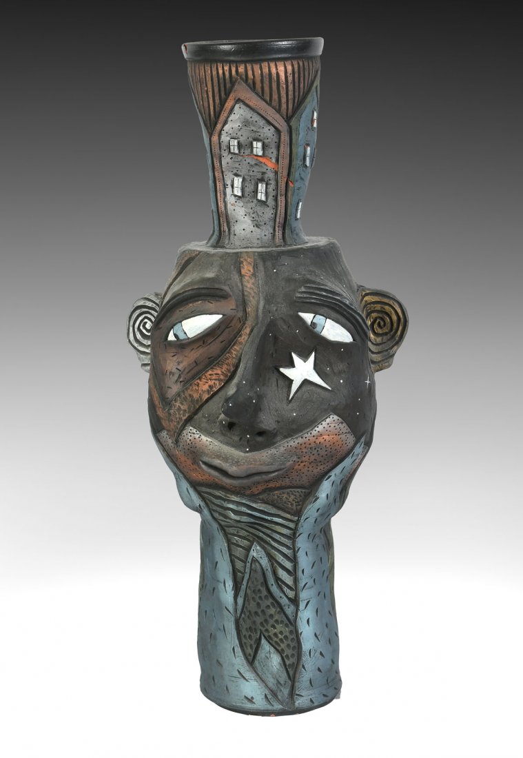 WONDERFUL LARGE DAVID STABLEY HEAD VESSEL: WONDERFUL LARGE DAVID STABLEY HEAD VESSEL: Really wonderful face vessel with houses atop his head. In the typical Stabley earth tones in a low relief design. Signed at base of the head and dated 1995.