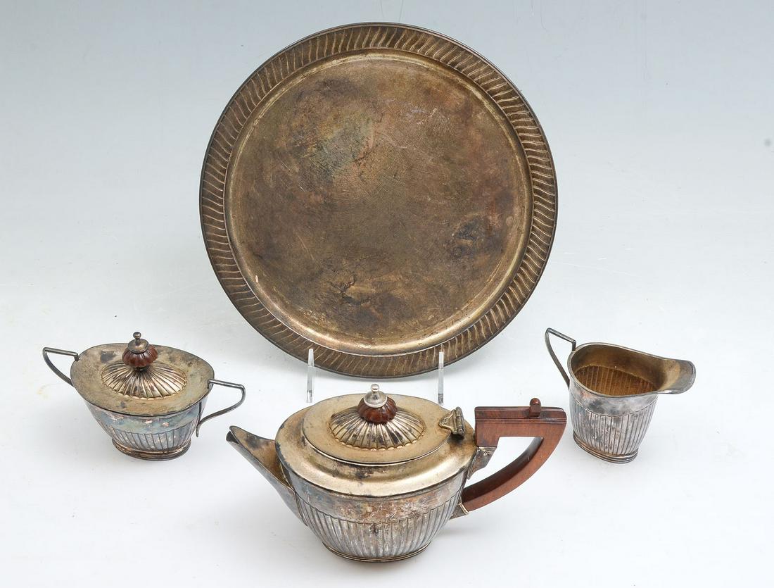 4 PC. STERLING SILVER TEA SET: 4 PC. STERLING SILVER TEA SET: Approx. 26.55 Troy ounces total weight. Comprising; 1- Tray, 1- Tea pot with wood handle & finial, 1- Covered sugar bowl with wood finial, & 1- Creamer. Largest Approx.