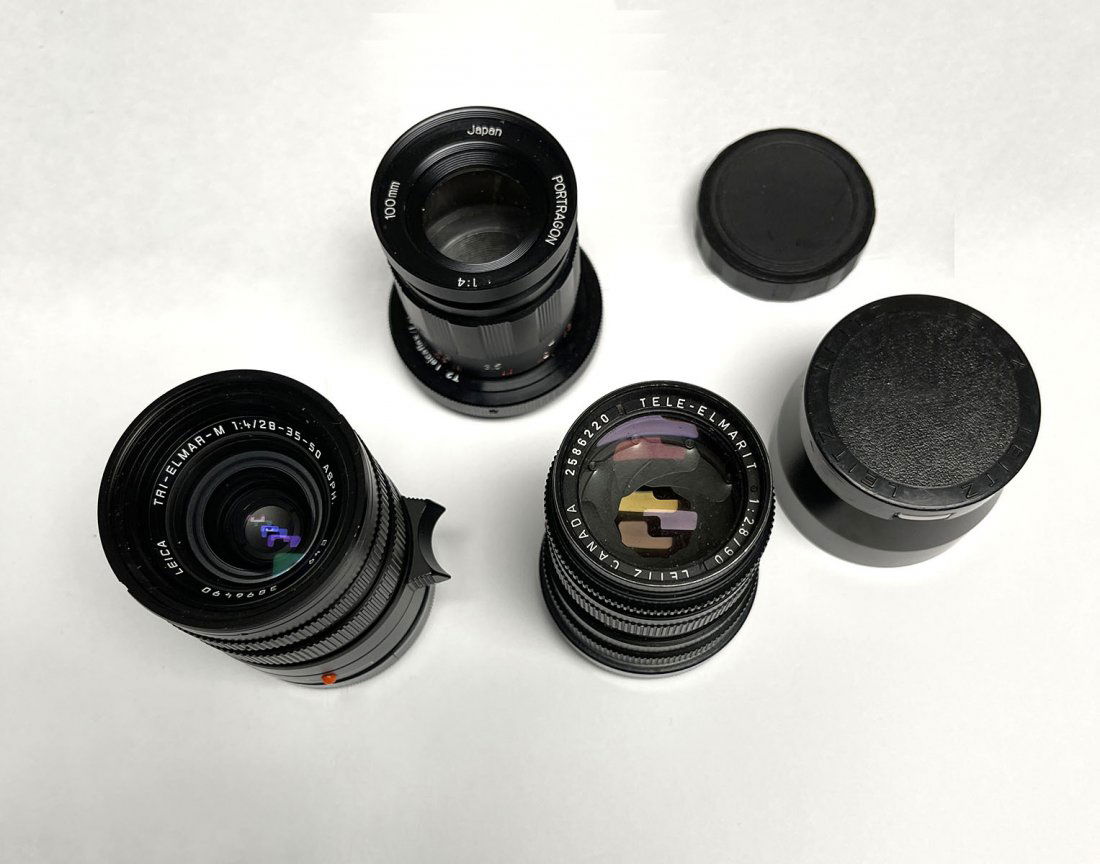 3 CAMERA LENSES: LEICA: 3 CAMERA LENSES: 1 Tri-Elmar-M Lens, 1:4/28-35-50 ASPH, 1 Leica Tri-Elmarit Canadian Zeiss 1:2.8/90 Lens and 1 Japanese Portragon 100MM 1:4 Lens. Estate of Jon Silengo, Photographer for the Military,