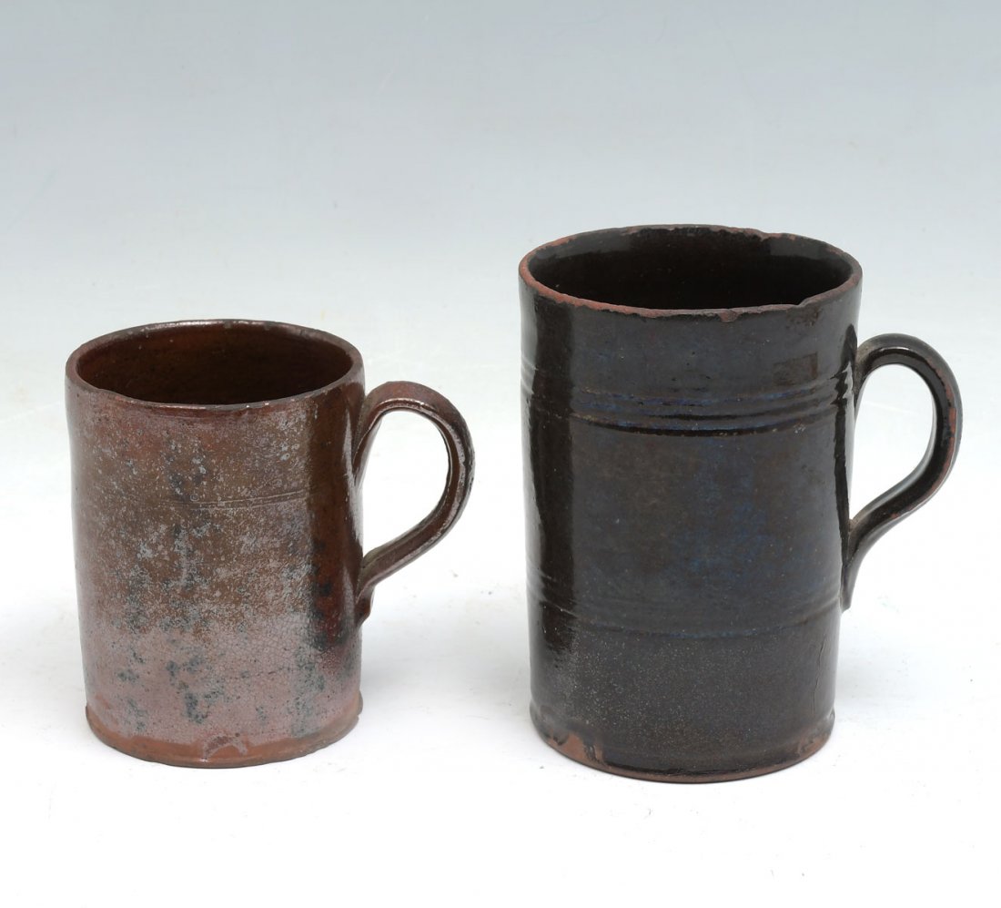 2 PC. 18TH CENTURY REDWARE MUGS: 2 PC. 18TH CENTURY REDWARE MUGS: 2- Redware mugs, having incised banding, by Daniel Bayley, of Newburyport, Mass., circa 1764-1799. Largest Approx. 6" h x 5.5" l at handle x 3.75" w.