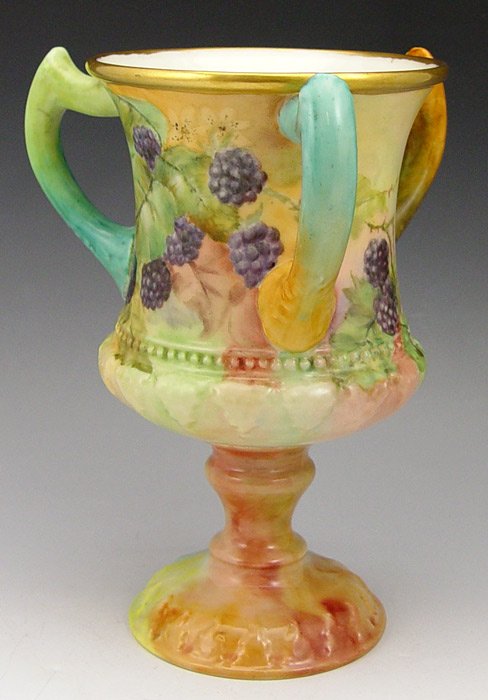 CERAMIC ARTS AMERICAN BELLEEK: CERAMIC ARTS AMERICAN BELLEEK PORCELAIN LOVING CUP: Hand painted in a berry design. Dated 1902. 8 1/2'' h.