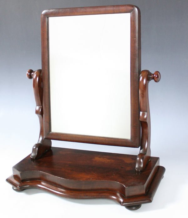 19TH CENTURY DRESSING / SHAVING MIRROR: MAHOGANY SHAVING OR DRESSING MIRROR: Shaped arms, curved front. Measures 21" h x 18" x 9"