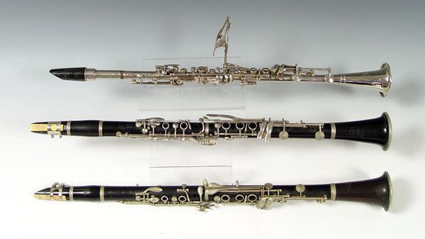 COLLECTION OF 3 CLARINETS SELMER & AUBERT: COLLECTION OF 3 CLARINETS SELMER & AUBERT: To include 1) Silvered finish Leon Aubert in H. A. Becker Music House case. Sold with sheet holder. Case 3" x 22 1/2" x 4 3/4". 2) F. Barbier wood body, sold