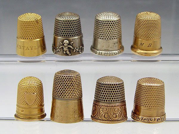COLLECTION OF 8 STERLING AND GOLD THIMBLES: COLLECTION OF 8 STERLING AND GOLD THIMBLES: Size 8, includes 2 18k gold (both monogrammed), 2 14k gold (1 monogrammed), 4 sterling. Approx. 10.4 grams 18k, 8.8 grams 14k, .6 troy oz. sterling.