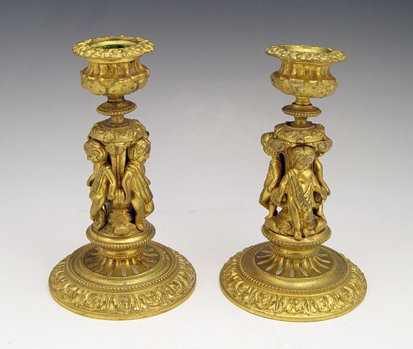 PR FRENCH DORE BRONZE CANDLE STANDS: PR EARLY FRENCH DORE BRONZE CANDLE STANDS: With 3 putti figures on each. 6" h x 3 1/2" base dia. EXACT AGE UNKNOWN.