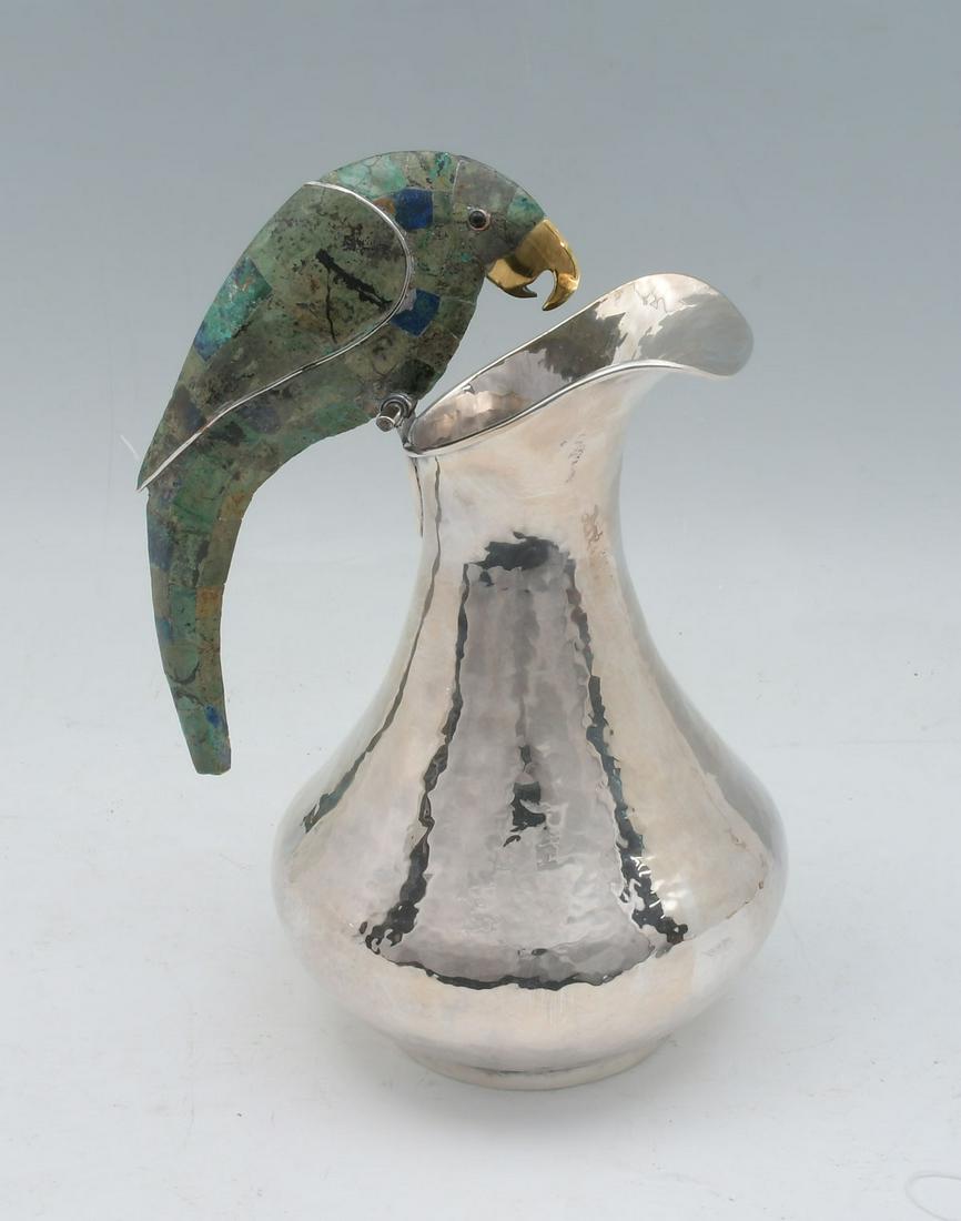 LOS CASTILLO MEXICAN PARROT PITCHER: LOS CASTILLO PLATEADO MEXICAN PARROT PITCHER: Total weight Approx. 41.08 Troy ounces. Large silverplate hammered pitcher with a hard stone clad parrot handle, malachite with spots of lapis, gold tone