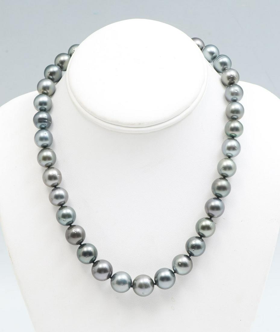 DARK GRAY TAHITIAN PEARL NECKLACE: DARK GRAY TAHITIAN PEARL NECKLACE: 35 dark gray cultured Tahitian pearls ranging in size 11-13 mm, form this 18" necklace with a 14K white gold plunger. Total weight is 85.7 grams. Sold with current F