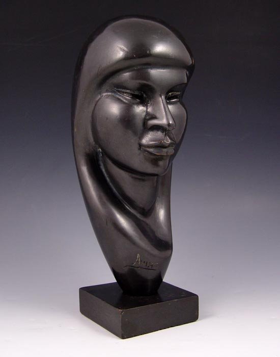 FLORES ARIAS CARVING: ARIAS, Flores, (Mexican, 20th C.): Carved and Ebonized Female Head, 10 1/4'', incised signature, faint stamp underneath.