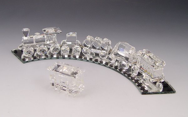 SWAROVSKI CRYSTAL 1990 5 PC TRAIN SET PLUS: SWAROVSKI CRYSTAL 1990 5 PC TRAIN: From the ''When We Were Young'' series, designed by Gabriele Stamey, approx. 9 1/8'' overall, includes Locomotive, Tender Car, Petrol Wagon, tipping car and Wagon Ca